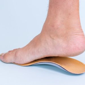 man-tries-right-leg-with-signs-flat-feet-orthopedic-insole-means-treatment-flat-feet_94064-2642